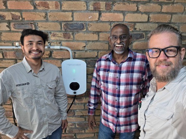 Happy customer with the SEQ EV Chargers crew beside a newly installed Zappi EV charger